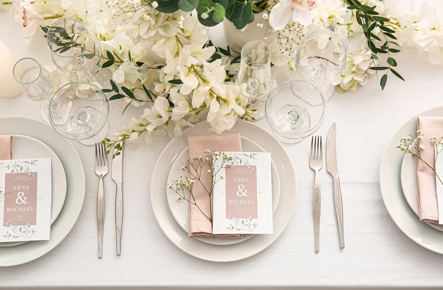 Ivory flowers, soft linen and personal place settings